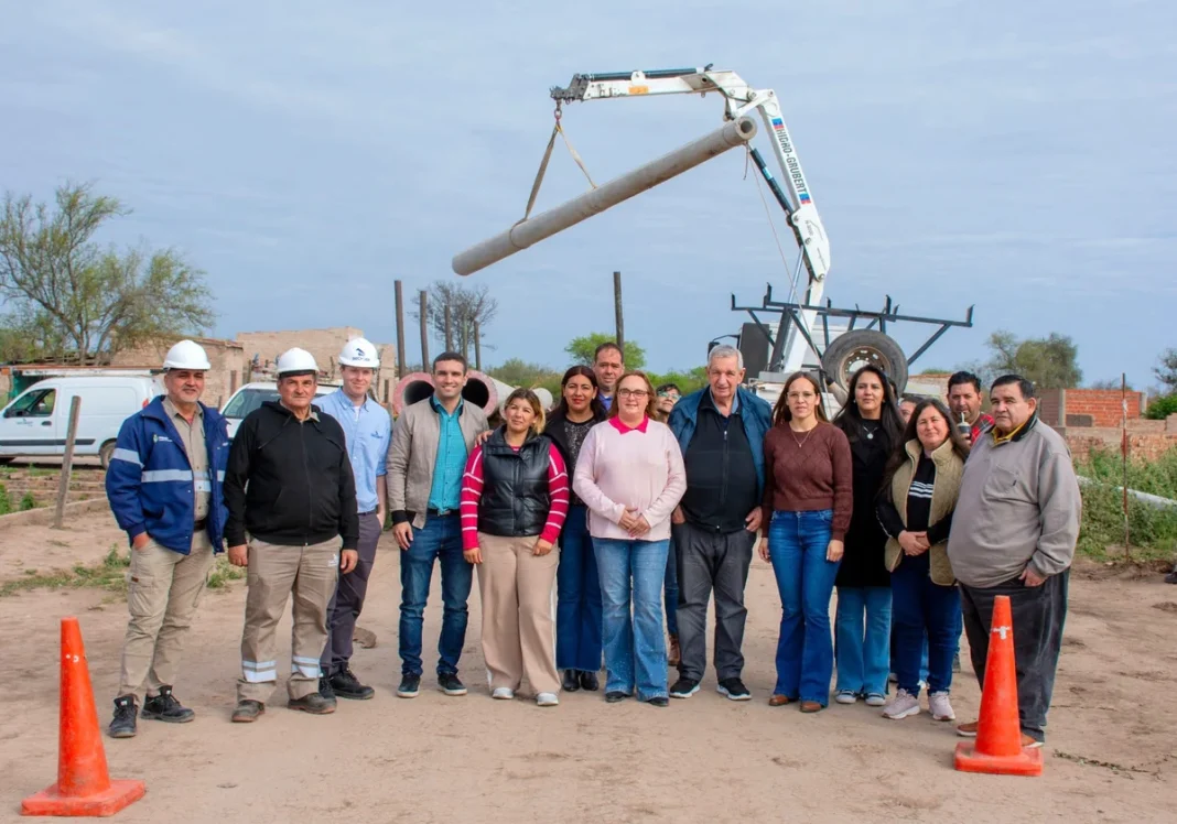 Grupo de personas junto a un camión con grúa canasto durante el inicio de obras eléctricas en Pampa del Infierno.