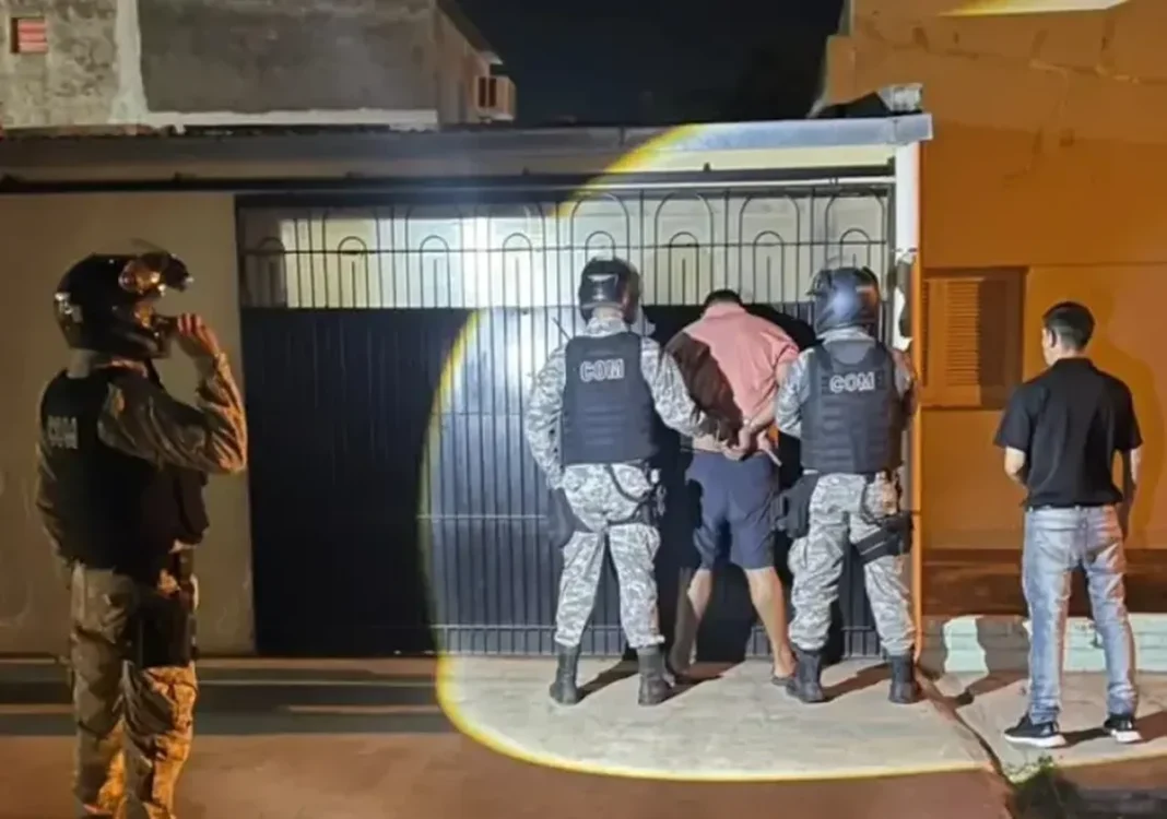Policías junto a un detenido durante un operativo nocturno en Villa Ángela